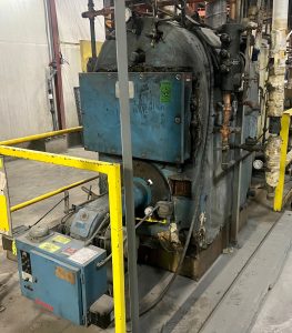Industrial boiler used for repair and servicing by Kelly Boiler, showcasing operational components and machinery in a workshop setting.